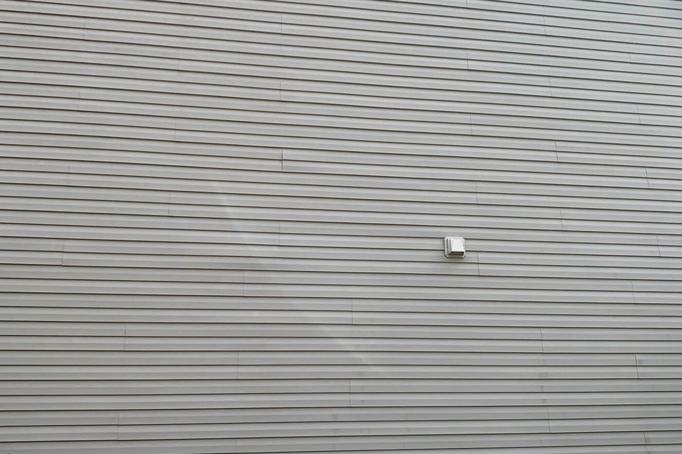 The same siding after a soft wash, the streaking gone and the colour even