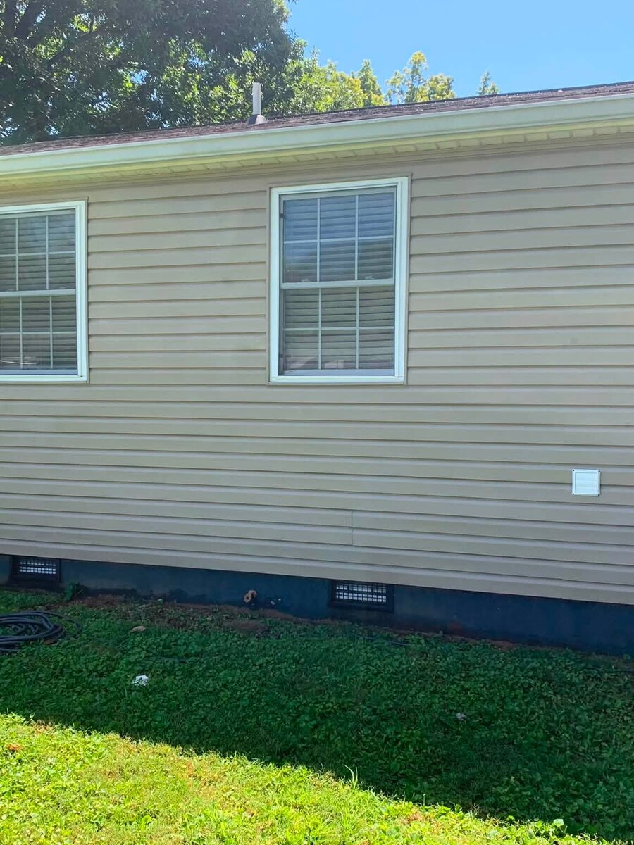 A long run of house siding after a soft wash, clean and evenly coloured